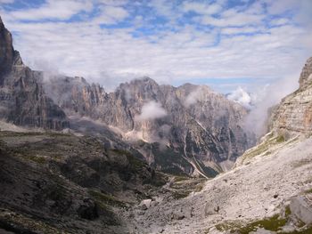 Scenic view of mountains against cloudy sky