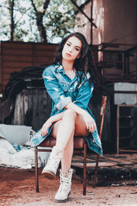 Portrait of beautiful young woman sitting outdoors