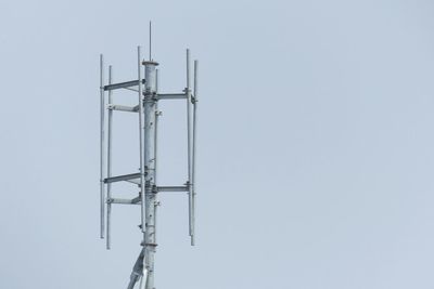 Low angle view of telephone pole against clear sky