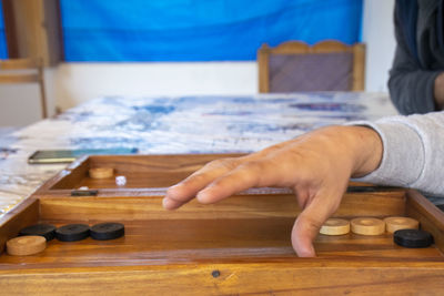 Cropped hand of man playing leisure game 