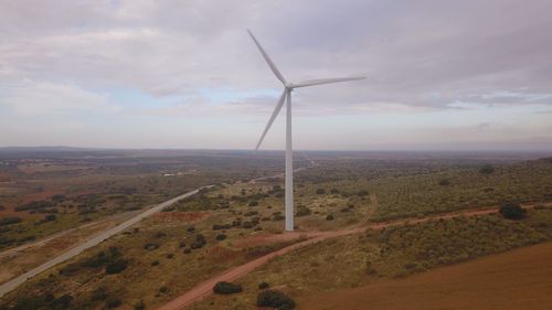 Windmill on field against sky