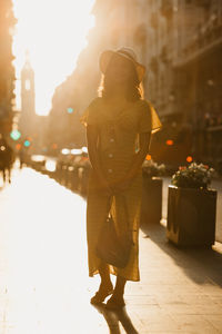 Low section of woman standing on street