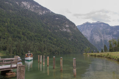 Scenic view of lake by mountains against sky