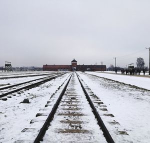 Tire tracks on snow against clear sky