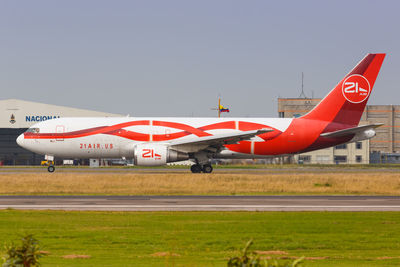 Airplane on airport runway against clear sky