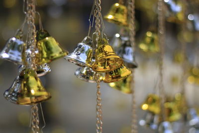 Close-up of small bells hanging outdoors