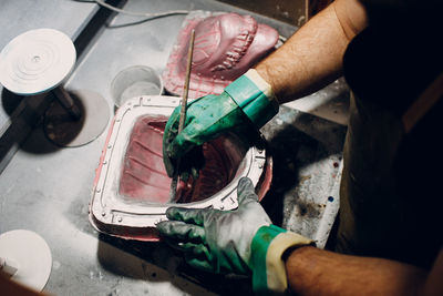 Midsection of man working at workshop