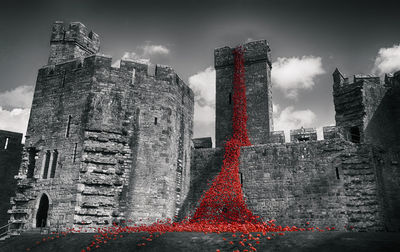 Fountain in city against sky