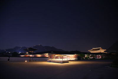 Illuminated buildings against sky at night