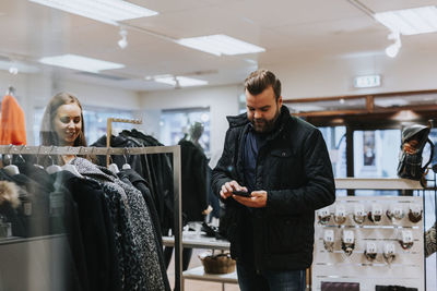 Man using cell phone in shop