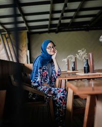 Woman sitting on chair at table