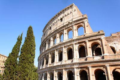 Low angle view of historical building against clear sky colosseum rome italy