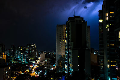 View of skyscrapers lit up at night