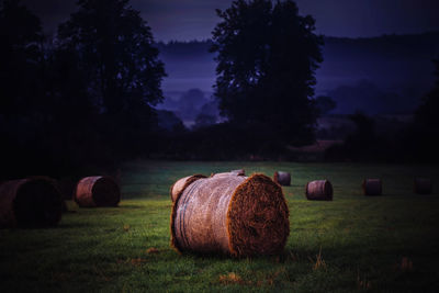 Hay bales on field against sky