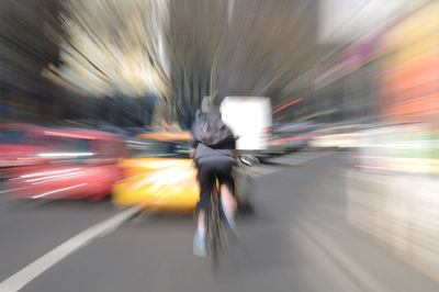 Blurred motion of man moving on road in city