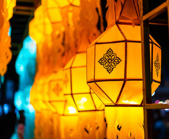 Close-up of illuminated lantern at temple