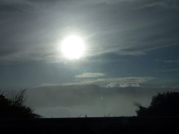 Low angle view of sun shining in sky