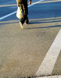 Low section of people walking on road