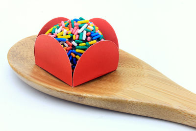 Close-up of heart shapes on cutting board against white background