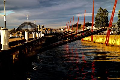 View of bridge over river in city against sky