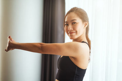 Portrait of young woman exercising in gym