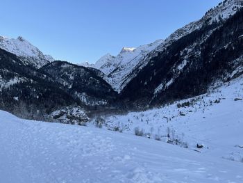 Scenic view of snow covered mountains against clear sky