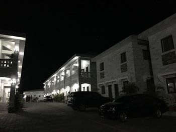 Cars on illuminated city at night