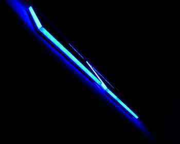 Close-up of illuminated light over black background
