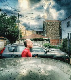 Woman standing against cloudy sky