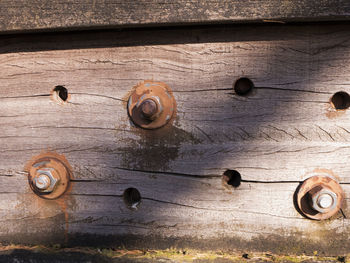 High angle view of old rusty metal on wood