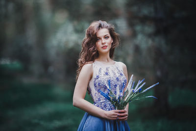 Portrait of young woman standing outdoors