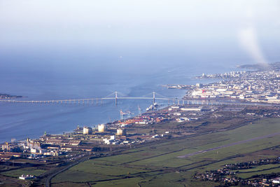 High angle view of cityscape by sea against sky