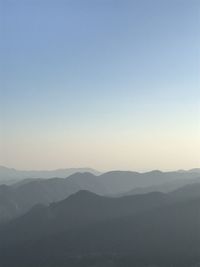 Scenic view of silhouette mountains against clear sky