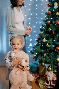 Portrait of cute girl decorating christmas tree