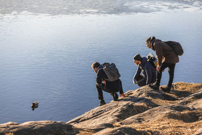 People on rocks by sea