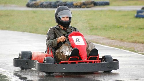 Man driving racecar on wet motor racing track