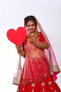 Portrait of smiling woman holding red umbrella