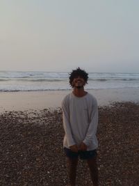 Full length of teenage girl standing on beach