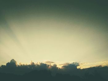 Low angle view of silhouette trees against sky