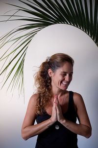 Woman making yoga pose at home with white background