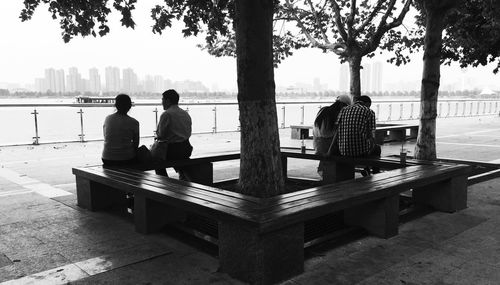 Rear view of man sitting on bench