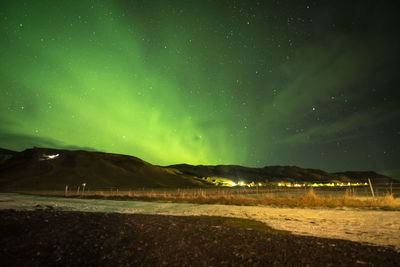 Scenic view of landscape against sky at night