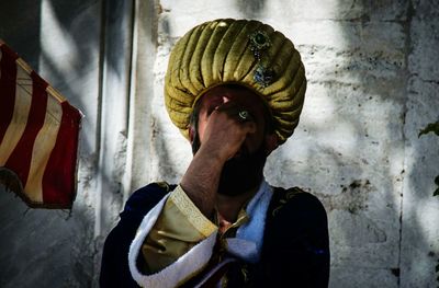 Man in turban against wall