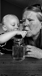 Close-up of baby boy feeding grandmother