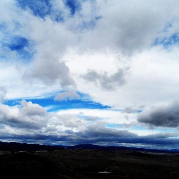 sky, tranquil scene, tranquility, scenics, cloud - sky, beauty in nature, cloudy, landscape, nature, cloud, mountain, cloudscape, idyllic, mountain range, non-urban scene, remote, day, outdoors, no people, blue