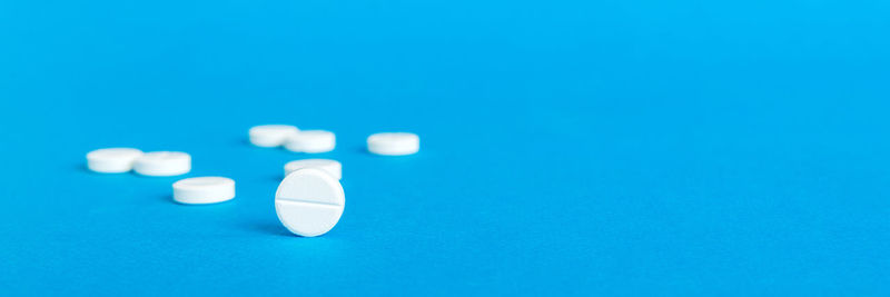 Close-up of pills on blue background