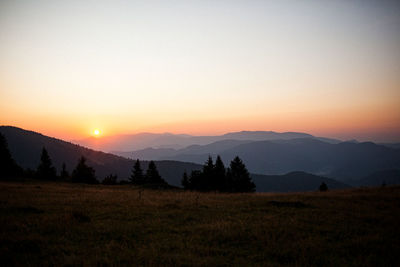 Scenic view of silhouette mountains against sky during sunset