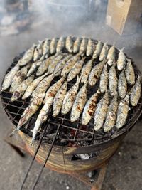 High angle view of fish on barbecue grill
