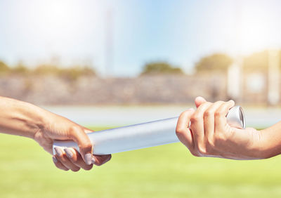 Cropped hand of man using mobile phone