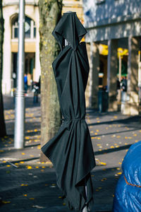 Rear view of woman with umbrella on street